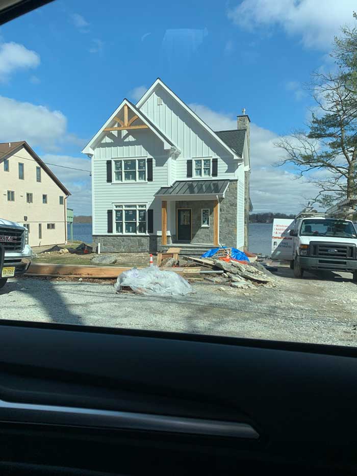 New Construction Gaf Charcoal Roof With Black Metal Porch Roof James Hardie Arctic White Board N Batten Siding