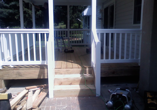 Screened Porch And Deck With White Railings